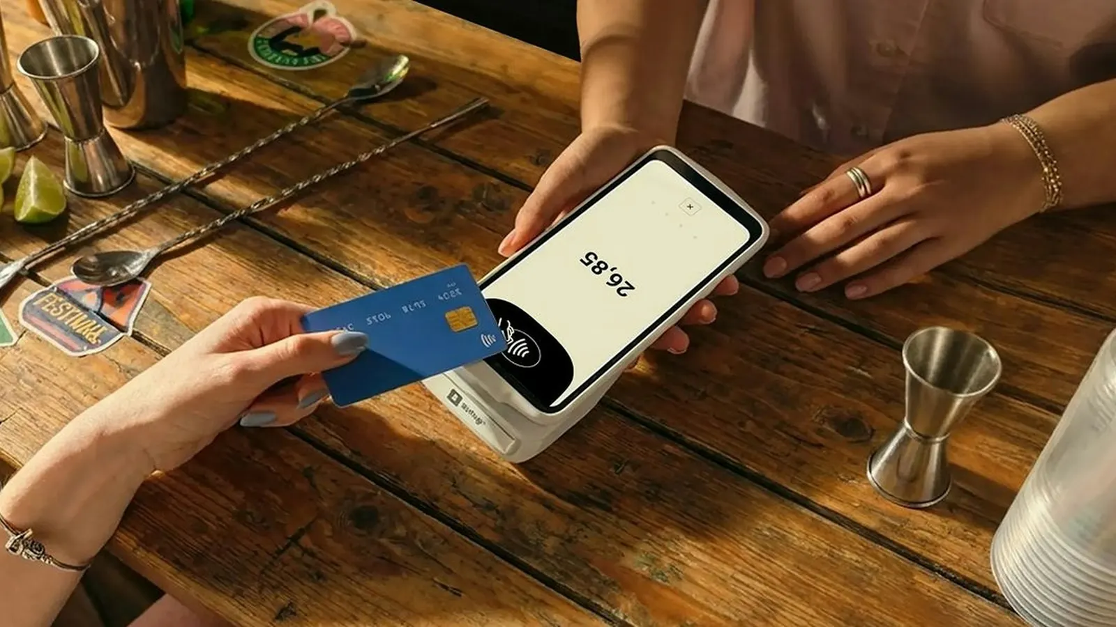 Person tapping a bank card on a payment terminal