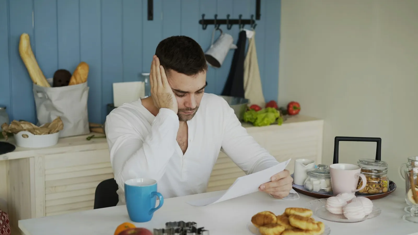 Man at a table reading through paperwork