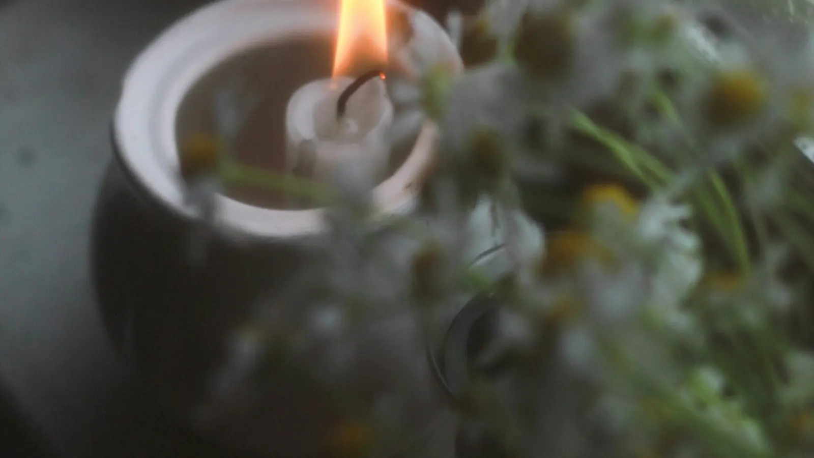 Lit candle on a window sill
