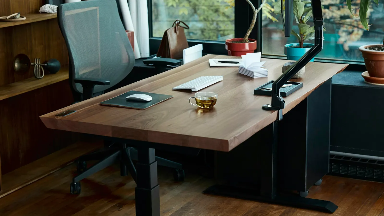 Wooden standing desk with a monitor in a home office