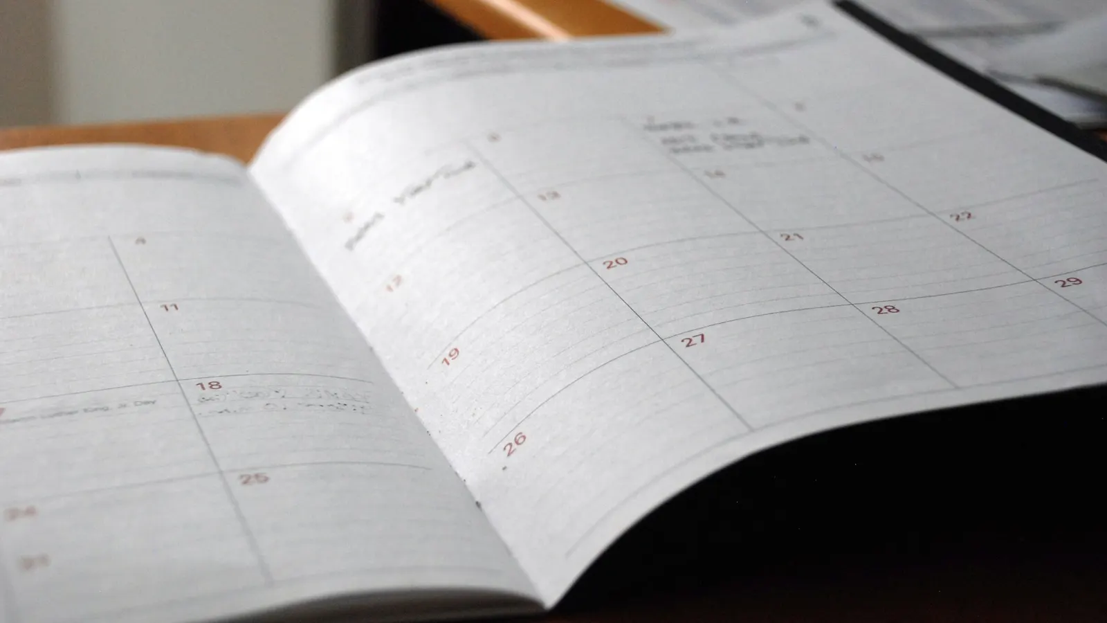 Open monthly planner on a wooden desk