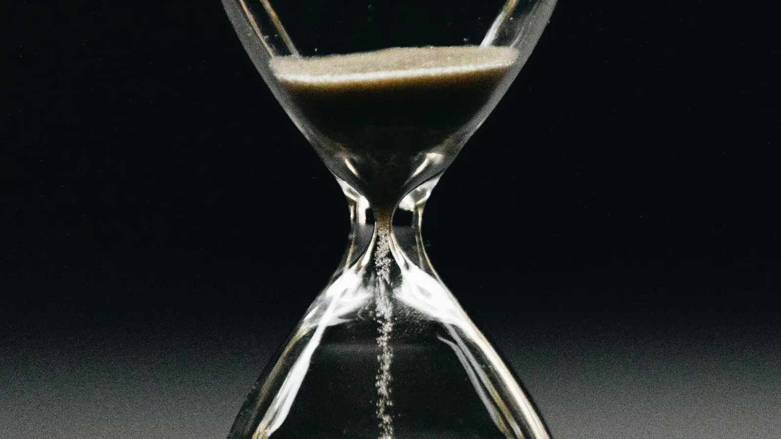 Clear hourglass with sand running through