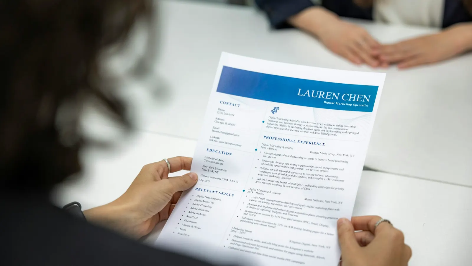 Woman reading a CV at a table