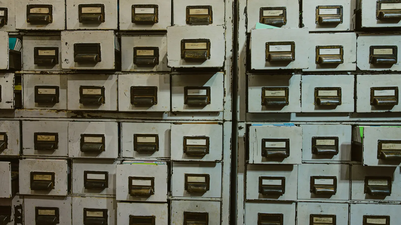 Rows of old labelled filing cabinets